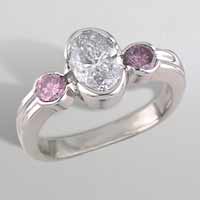 oval diamond with pink diamonds on the side engagement ring